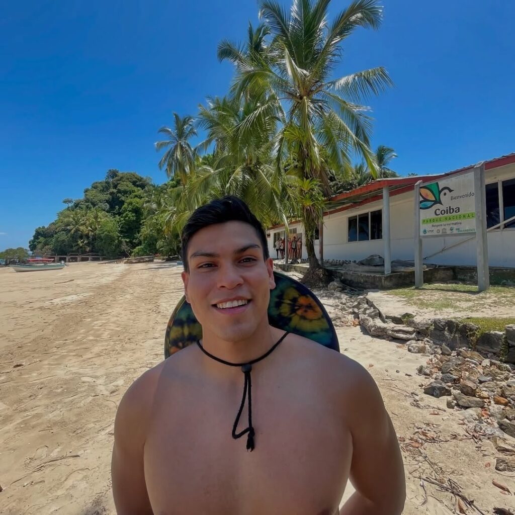 Coiba Island beach lined with palm trees and turquoise sea