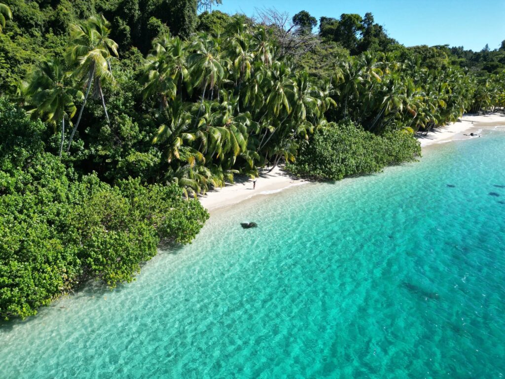 Boat crossing calm bay near Coiba National Park