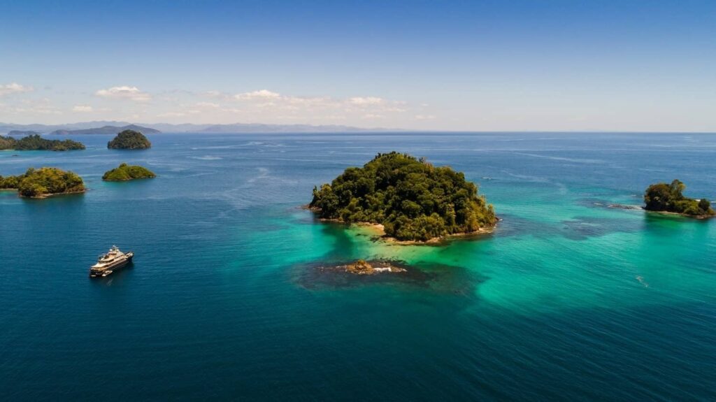Travelers on boat surrounded by blue water near Coiba