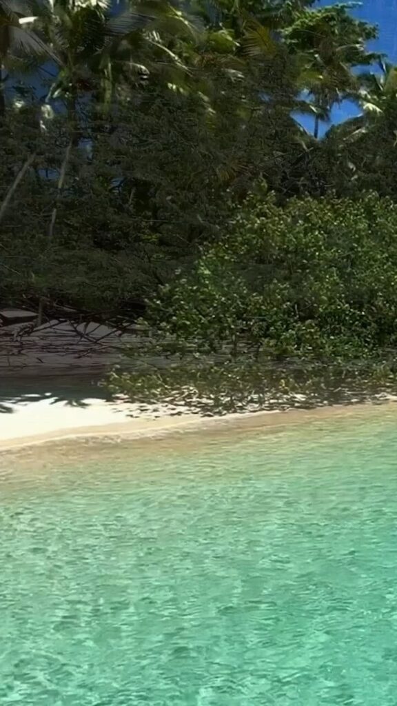 Travel photo of boat passing rocky headland near Coiba