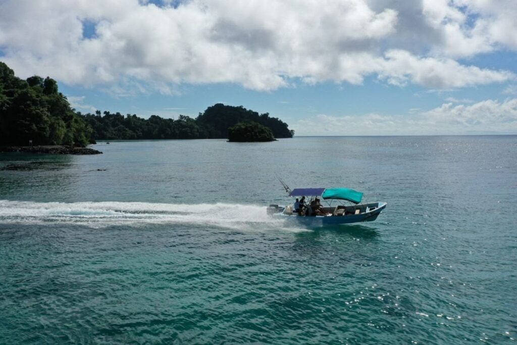 Travelers on boat enjoying Coiba Island scenery