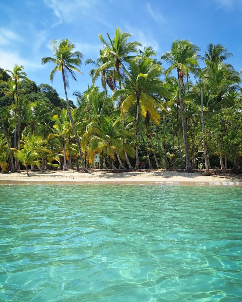 Solo scuba diver suspended in deep blue water in Coiba