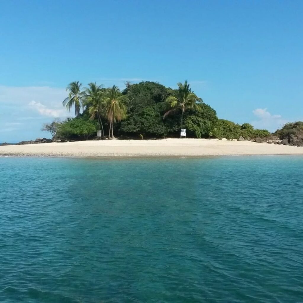 Boat tour group relaxing on Coiba beach