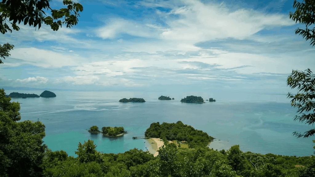 Boat tour passing rocky outcrop near Coiba