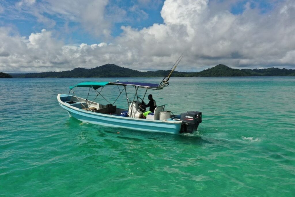 Holiday-style photo of travelers on Coiba beach