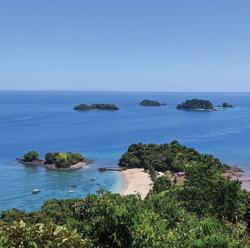 Traveler walking along quiet tropical beach near Coiba